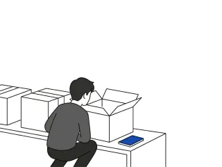 A small back-facing figure crouches to look inside an open cardboard box at the near end of a row of identical sealed boxes, a cobalt-blue notebook resting on the surface beside it.