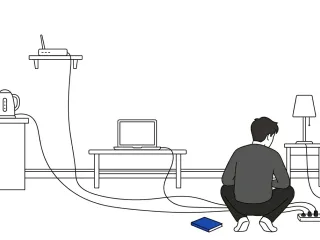 A small back-facing figure sits on the floor of an interior room examining a power strip into which power cords from a kettle, a router, a laptop, and a lamp all converge; a cobalt blue notebook lies on the floor beside the figure.